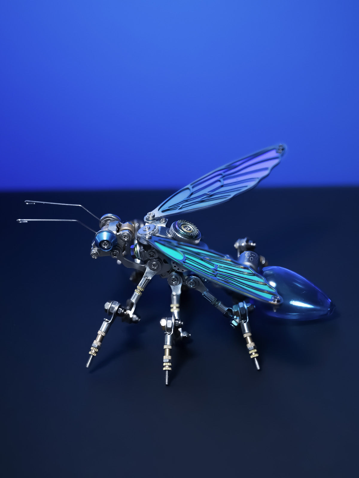 Assembled Glow Ant DIY model glowing beside its kit parts