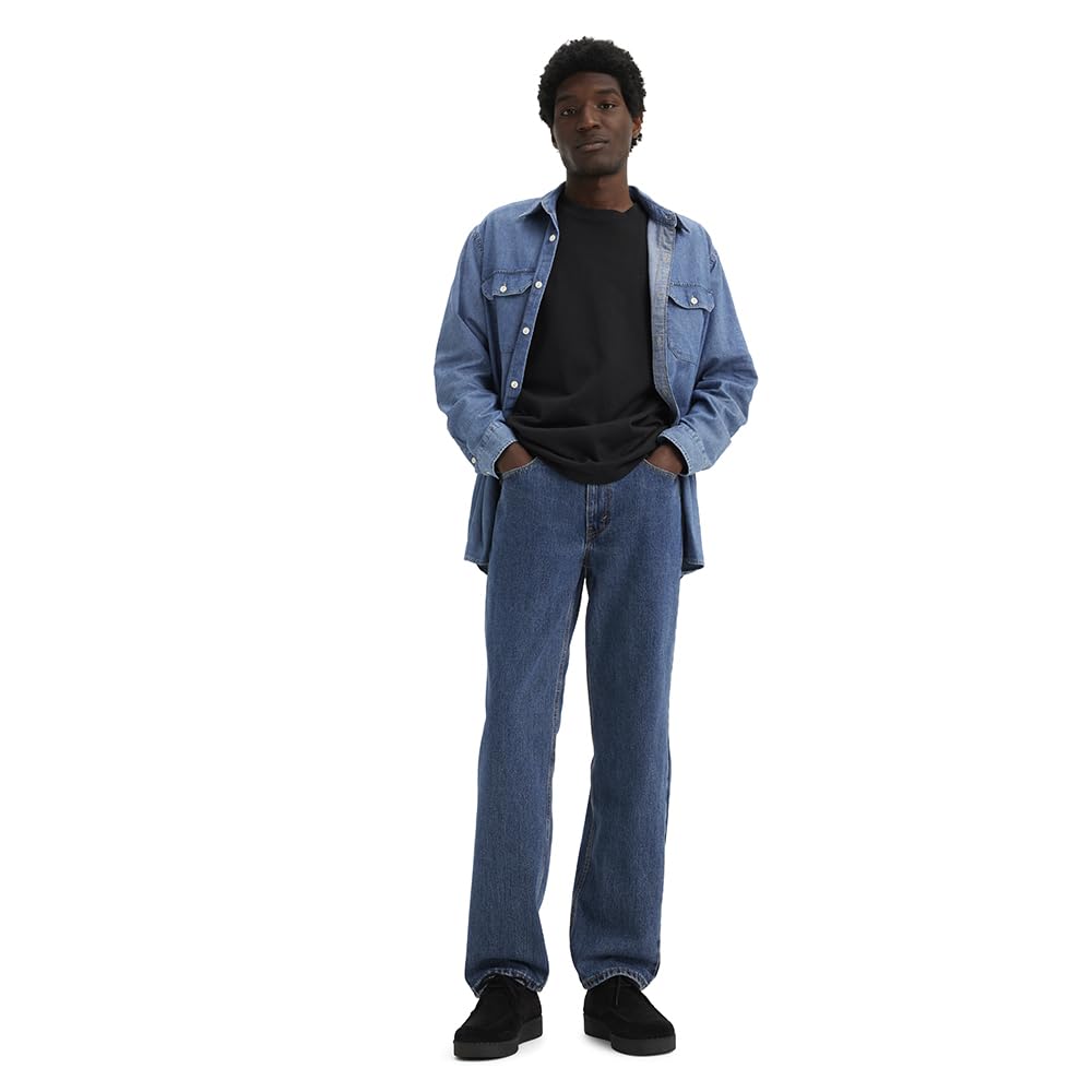 Men's 505 regular fit jeans in medium indigo, model standing to show the regular fit silhouette