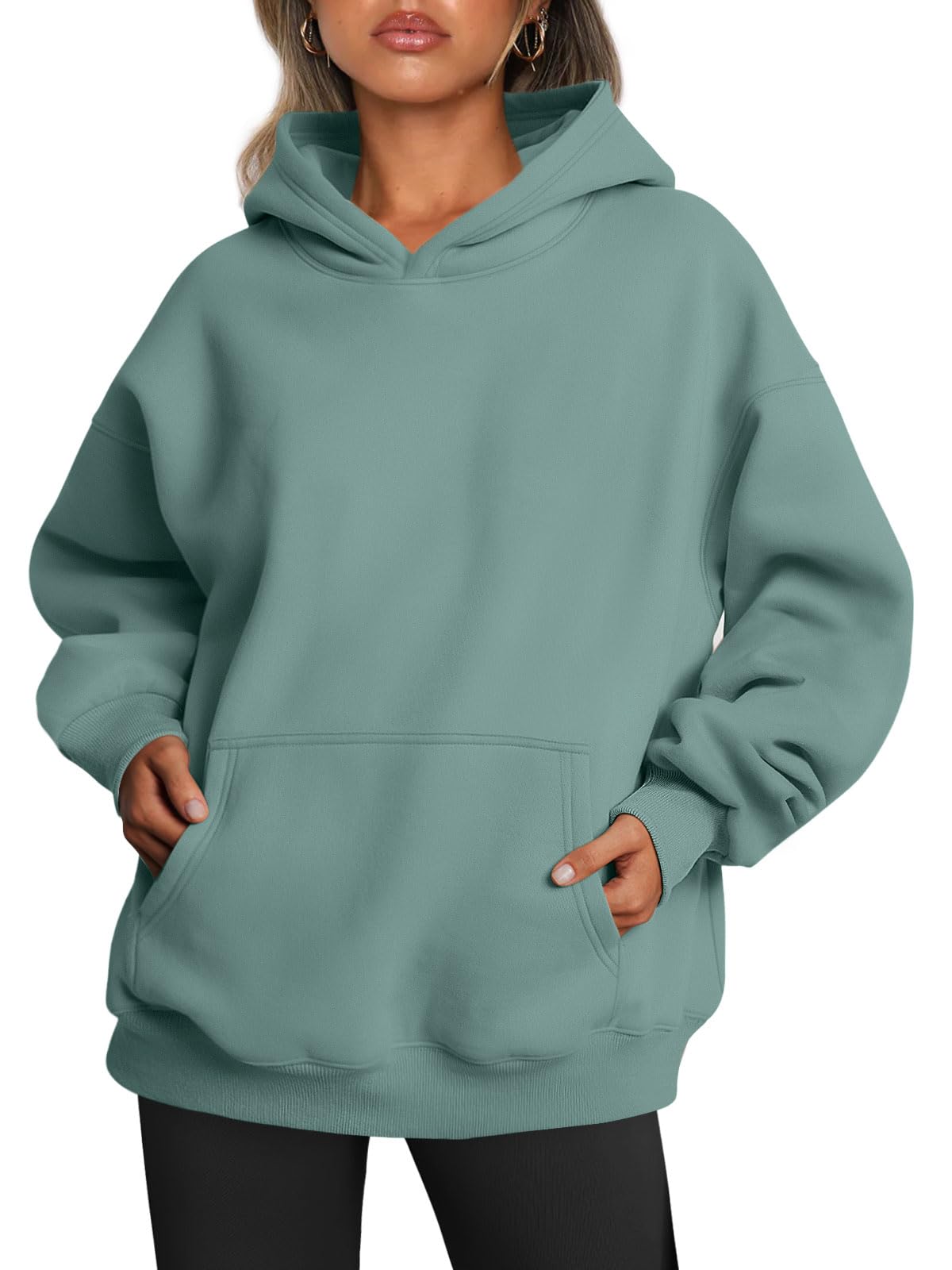 Sleeve and cuff detail of the oversized hoodie in a soft neutral tone