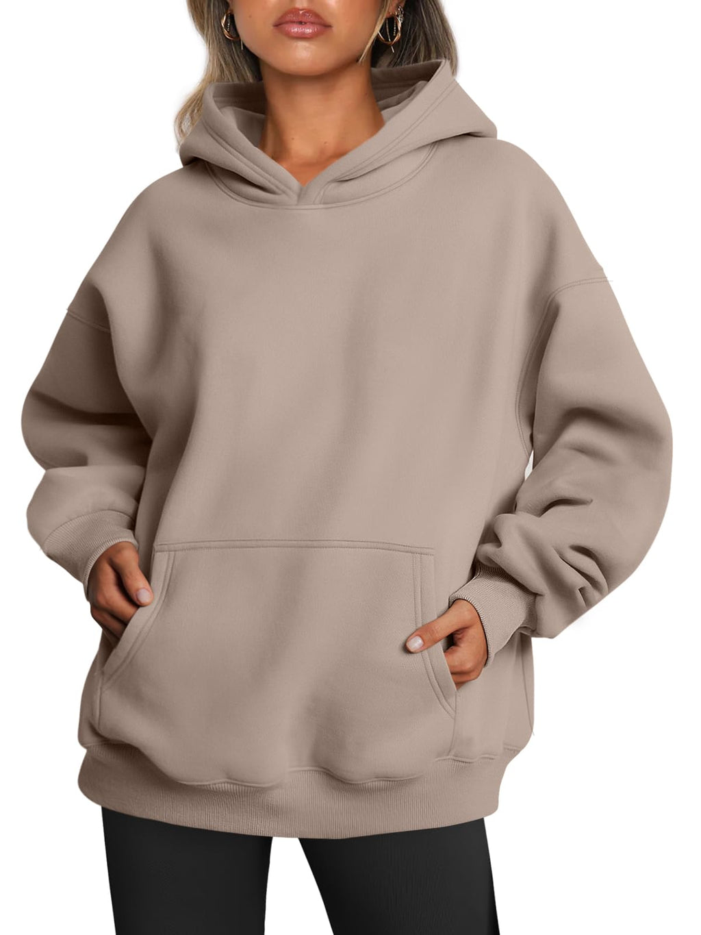 Oversized hoodie worn with hands in pocket, front-facing lifestyle view