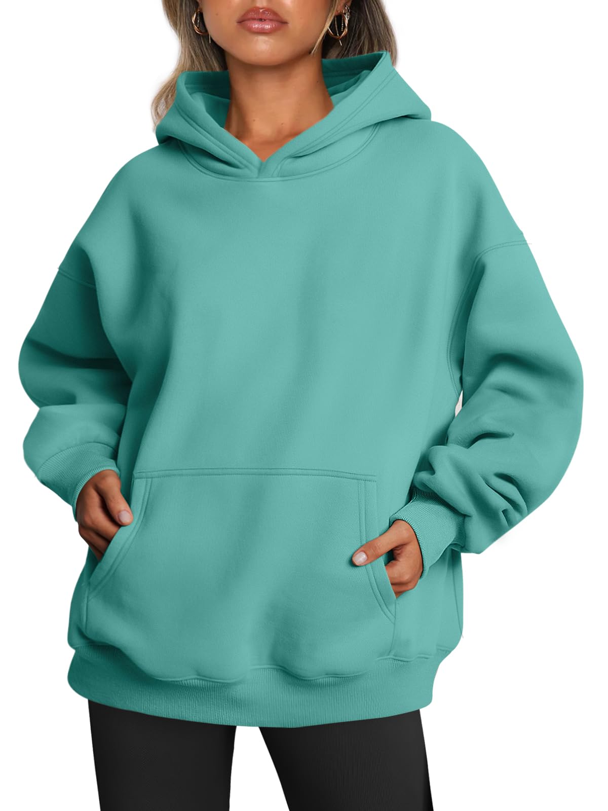 Model wearing the oversized hoodie with hands in the front pocket