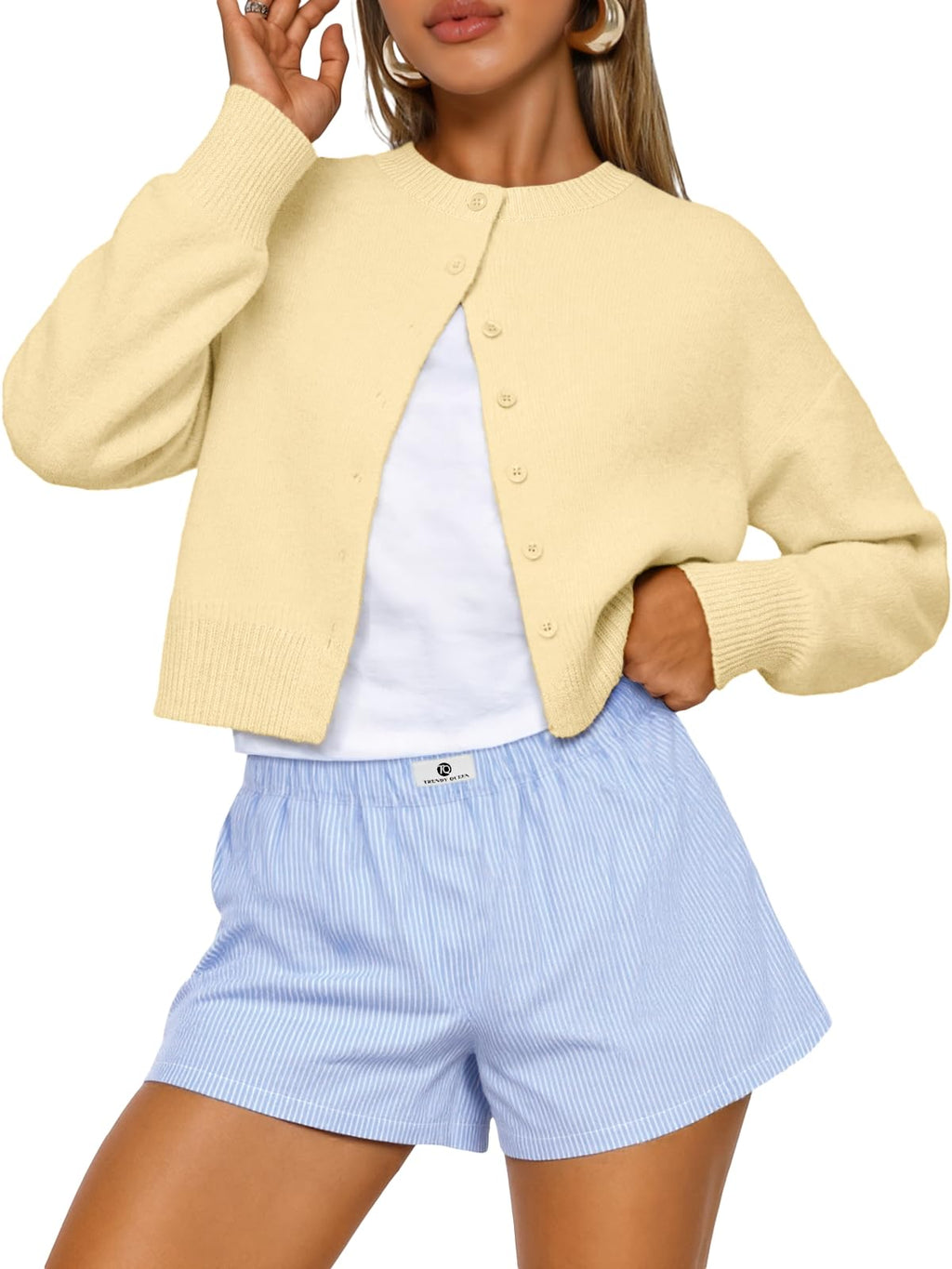 Full-length view of the cropped cardigan sweater on a standing model
