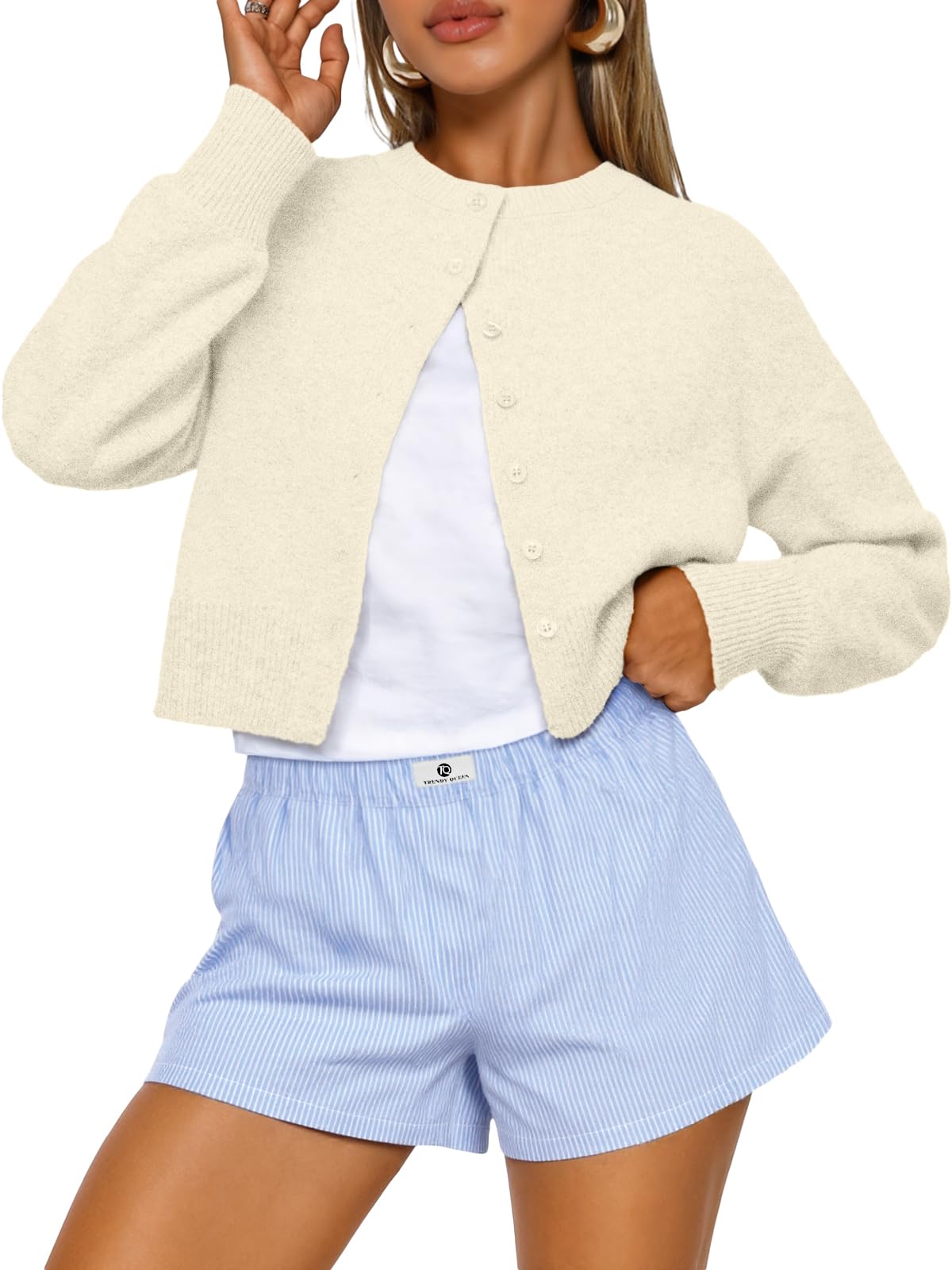 Cropped cardigan sweater laid flat showing the full shape and cut
