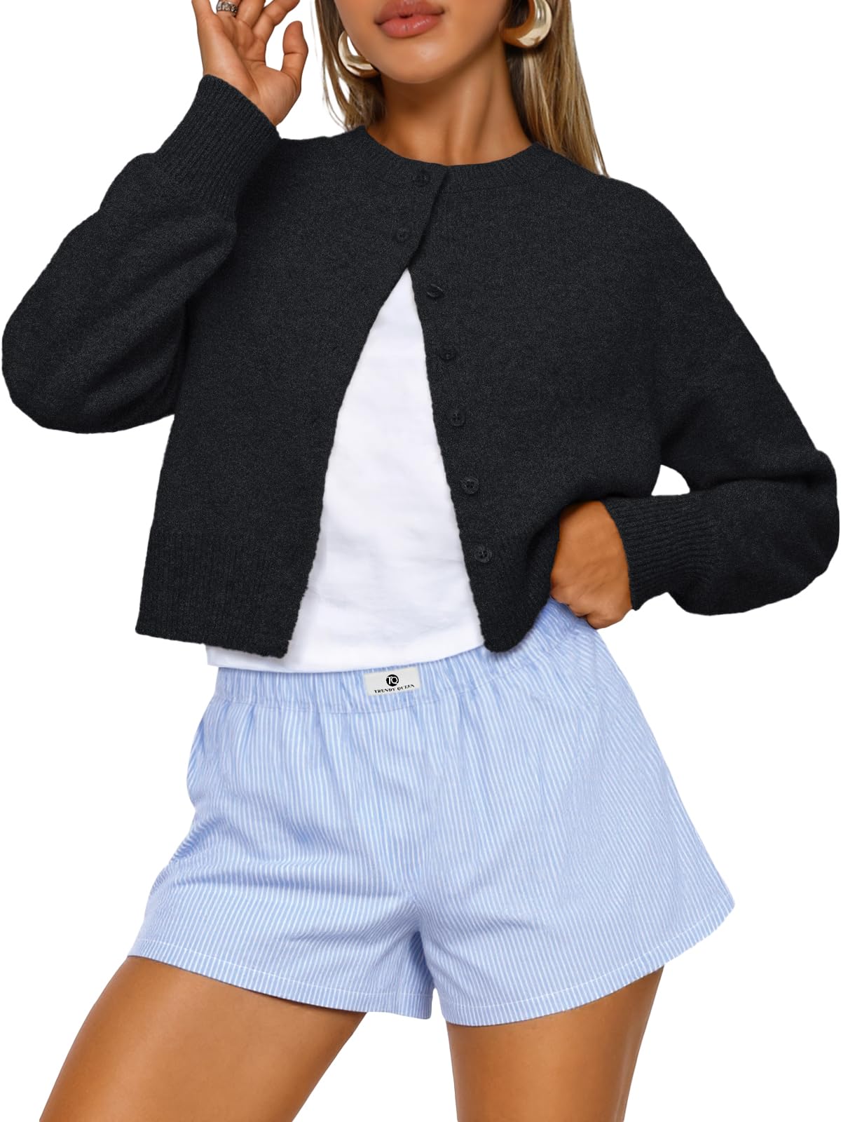 Flat lay of the cropped cardigan sweater folded to show the knit material