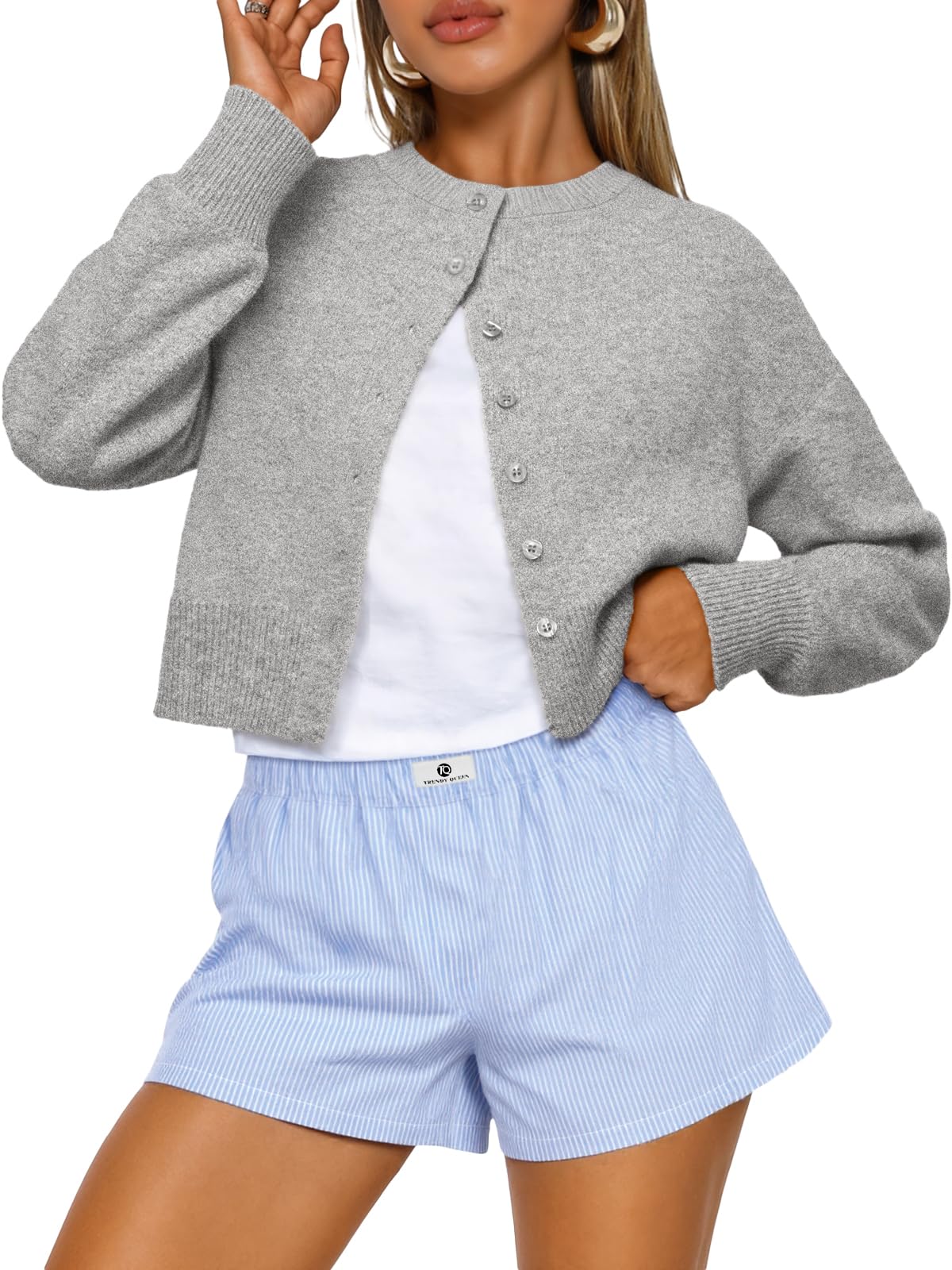 Women's cropped cardigan sweater folded flat to show the knit fabric