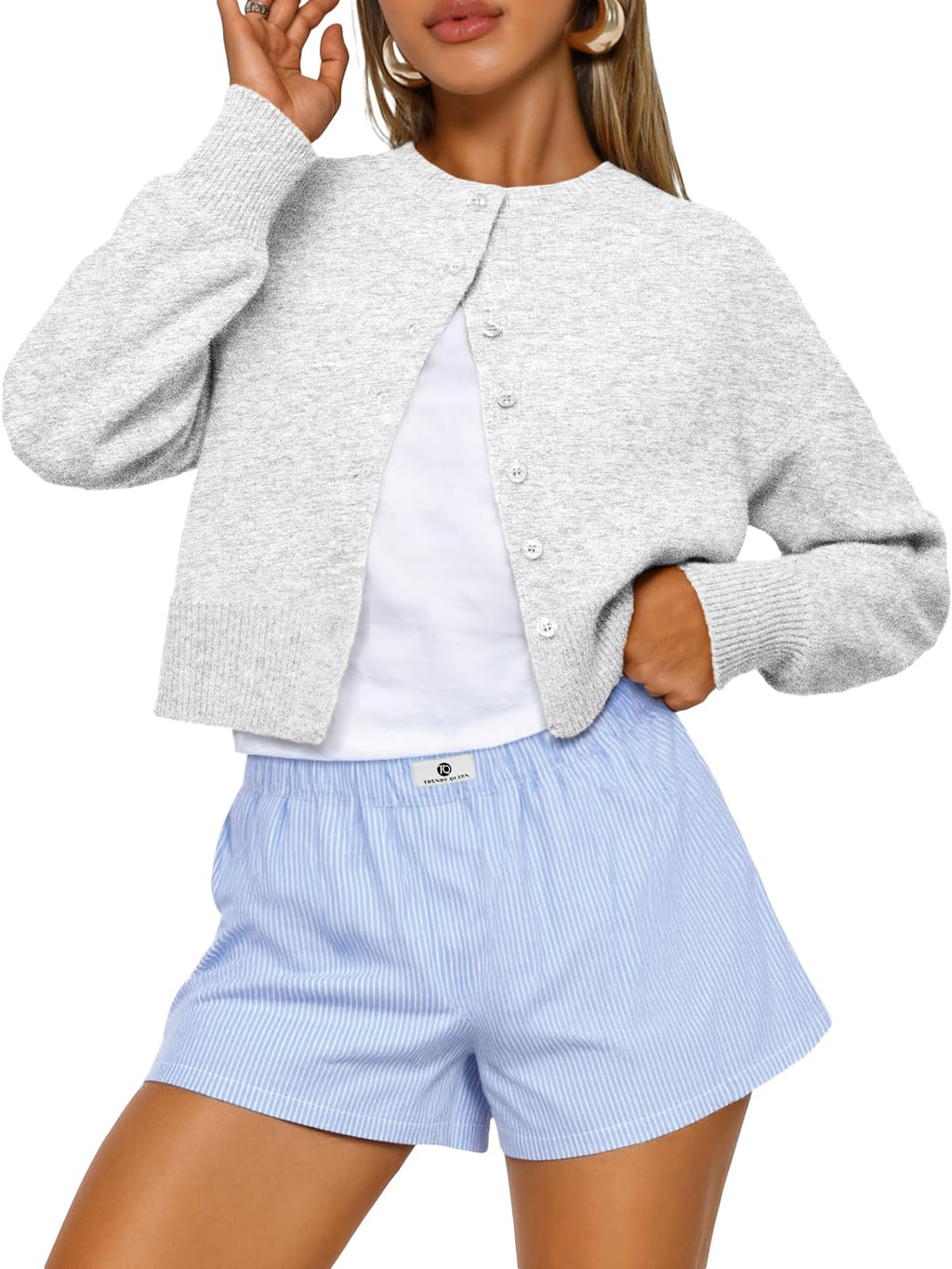 Cropped cardigan sweater paired with trousers in a fall outfit shot
