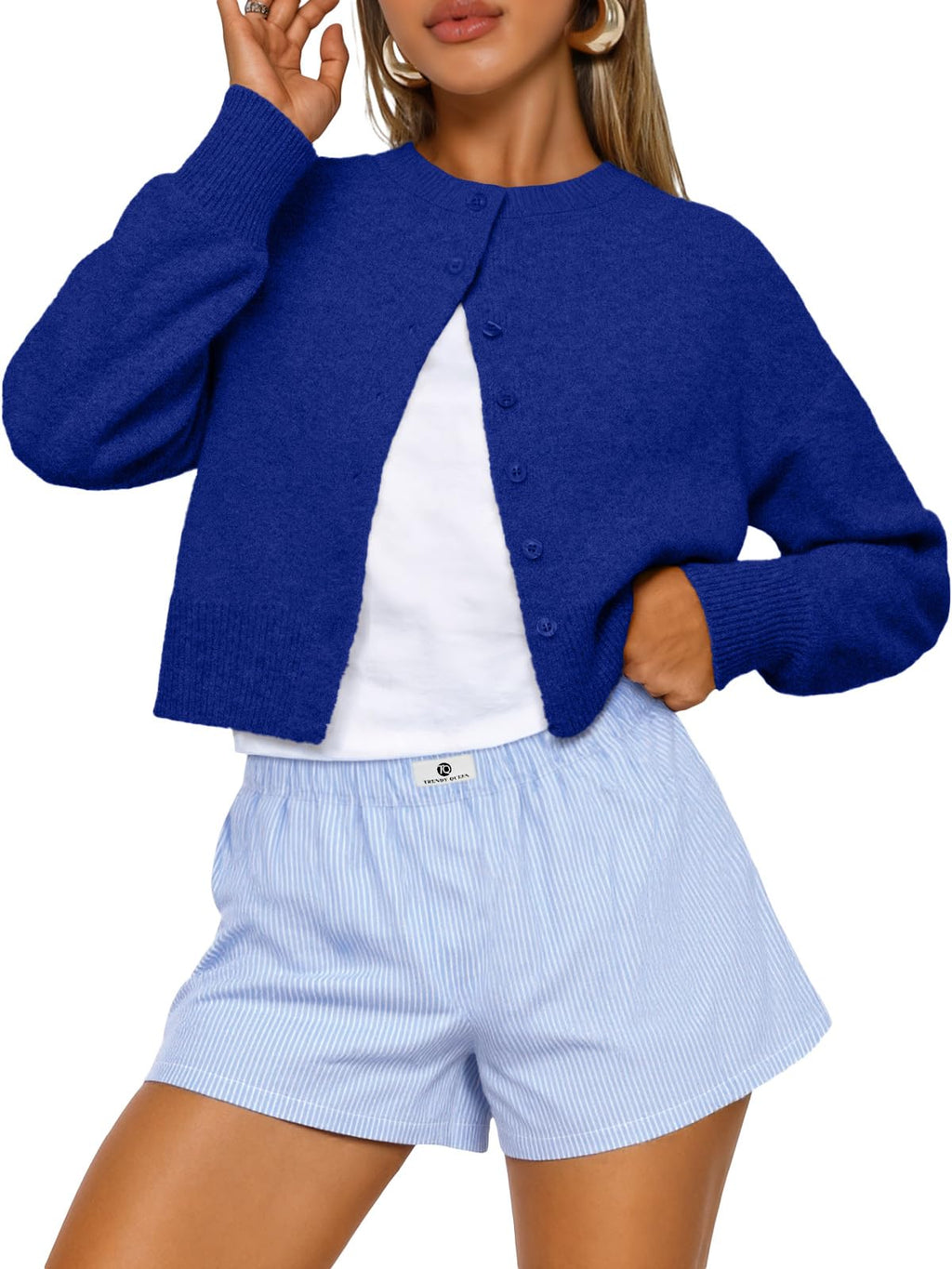 Model wearing the cropped cardigan open over a top for a casual fall look