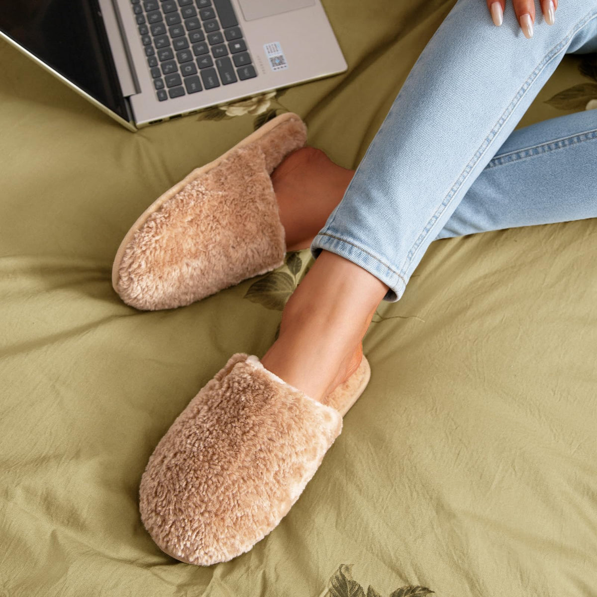 Top-down view of a pair of women's plush indoor slippers with warm fuzzy texture
