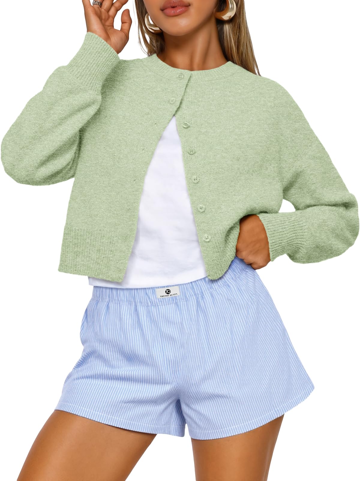 Flat lay of the cropped cardigan sweater with its sleeves spread out