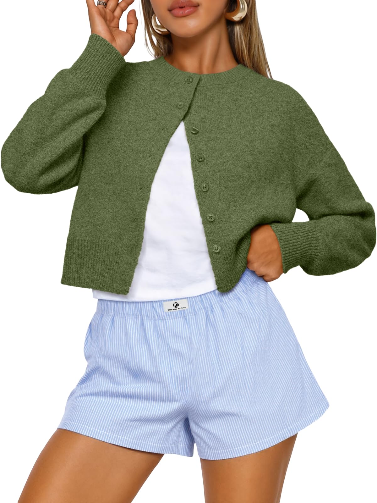 Cropped cardigan sweater buttoned up, front view on a plain background