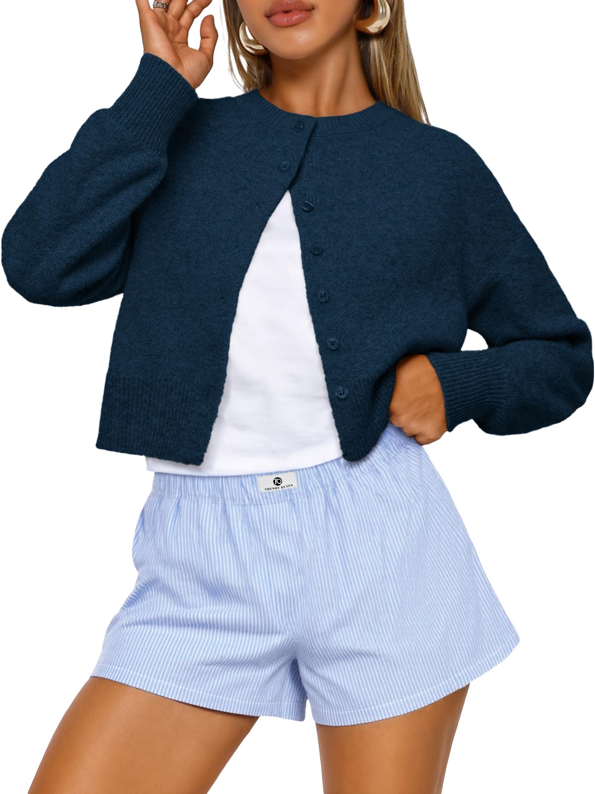 Model wearing the cropped cardigan open over a top for a casual fall outfit