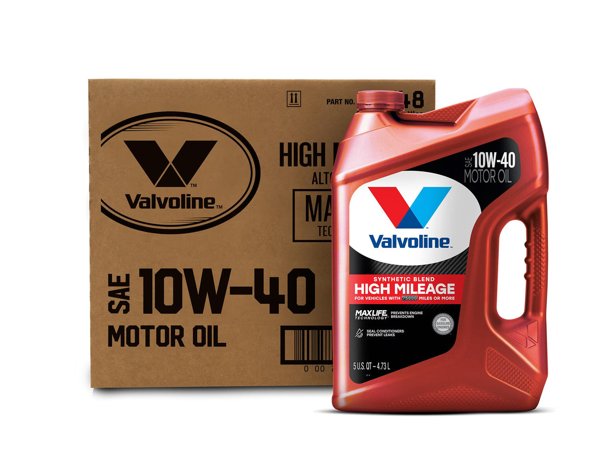 5-quart motor oil jug beside dipstick checking oil level in an older car