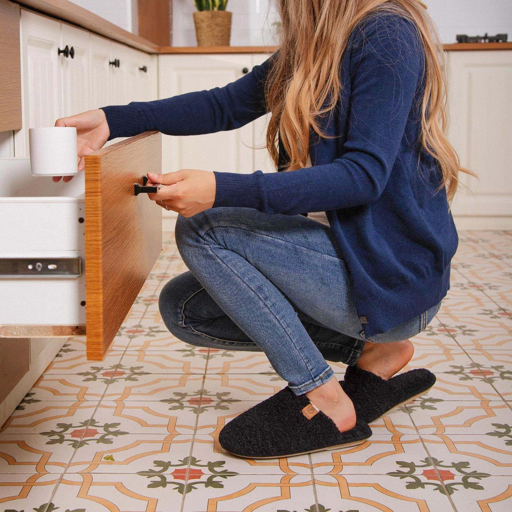 Women's fuzzy slippers laid flat showing both shoes and memory foam footbeds