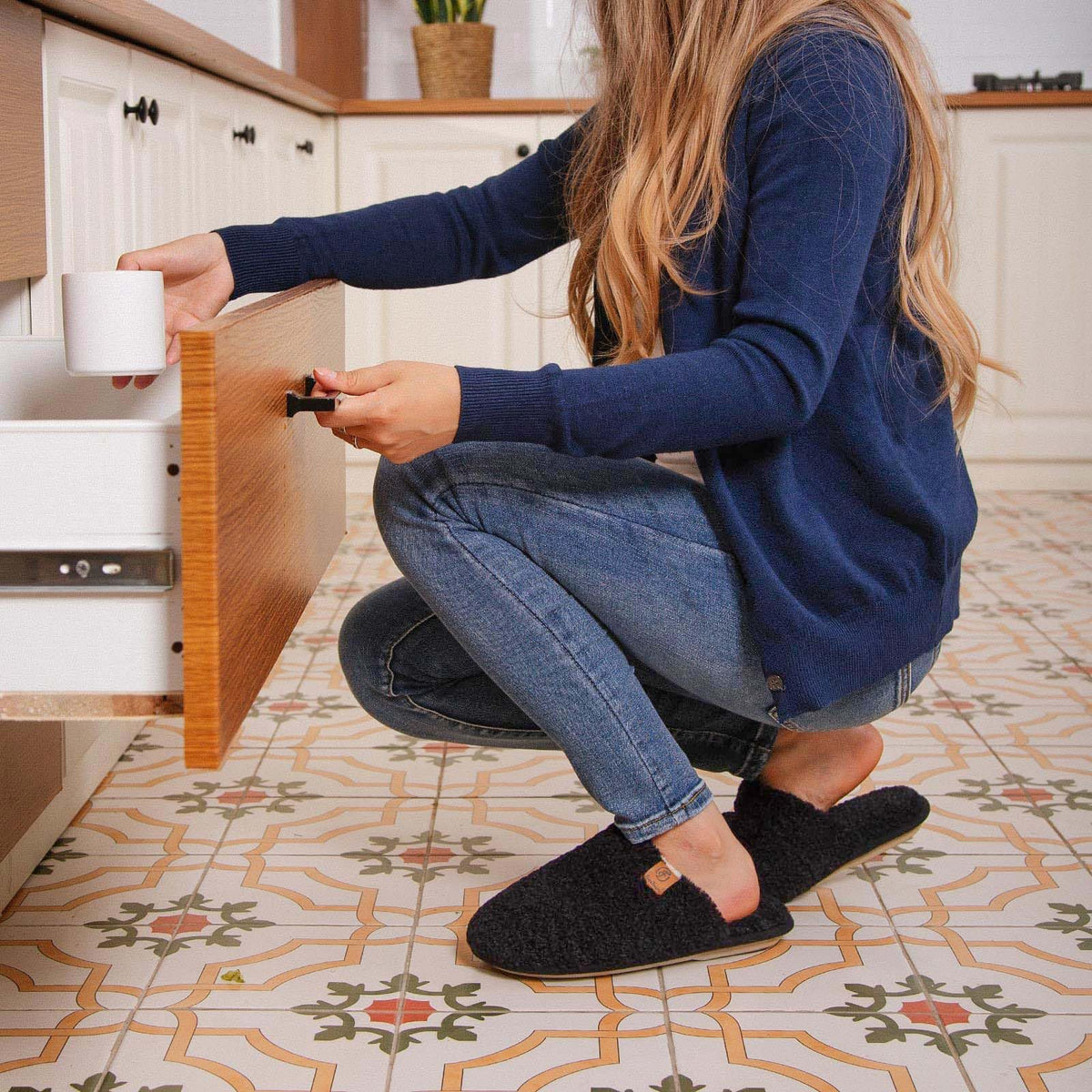 Women's fuzzy slippers laid flat showing both shoes and memory foam footbeds